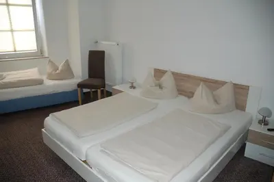 Ein Bett oder Betten in einem Zimmer der Unterkunft Hotel Kurfürst Garni