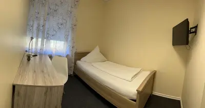 Ein Bett oder Betten in einem Zimmer der Unterkunft Sleep & Living Forst ehem Corona