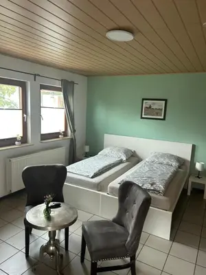 Ein Bett oder Betten in einem Zimmer der Unterkunft Pension Zum Paradies
