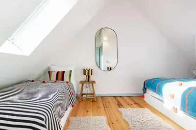 Ein Bett oder Betten in einem Zimmer der Unterkunft Zita Ferienhäuser - Ferienhaus Feni