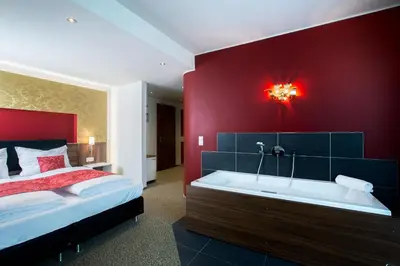 Ein Bett oder Betten in einem Zimmer der Unterkunft Weingut Schreieck VINOTEL & GUTSHAUS