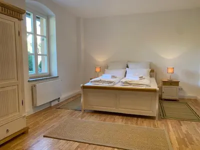Ein Bett oder Betten in einem Zimmer der Unterkunft Charmantes Gästehaus Maya im Schloß und Hofgut Langenzell