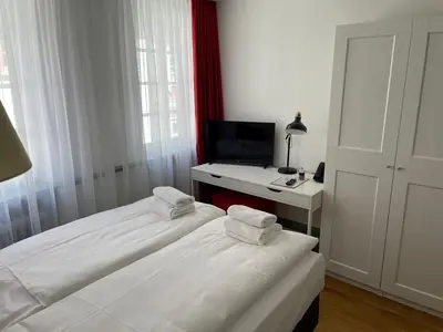 Ein Bett oder Betten in einem Zimmer der Unterkunft Palmbräu Altstadt Appartments