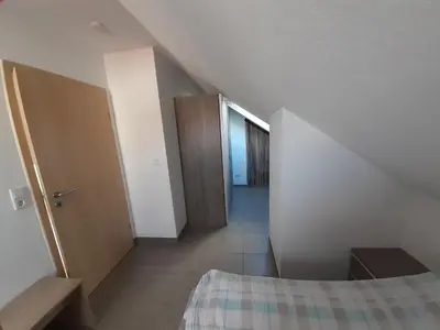 Ein Bett oder Betten in einem Zimmer der Unterkunft Fewo Steinhohle, DG 45qm, 1 Schlafzimmer & 1 Wohn-Esszimmer mit Bett